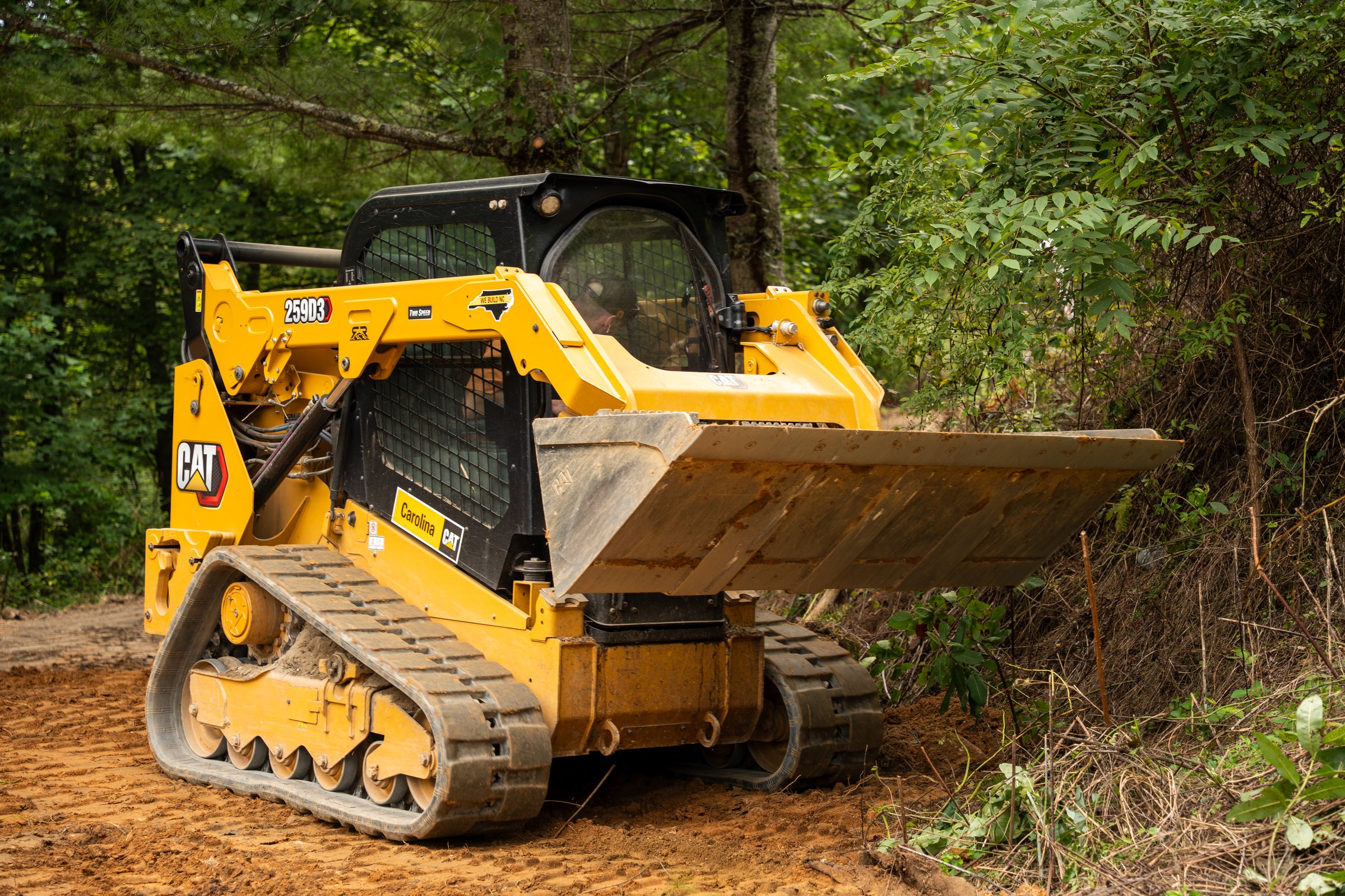 CAT 259D3 track loader moving dirt